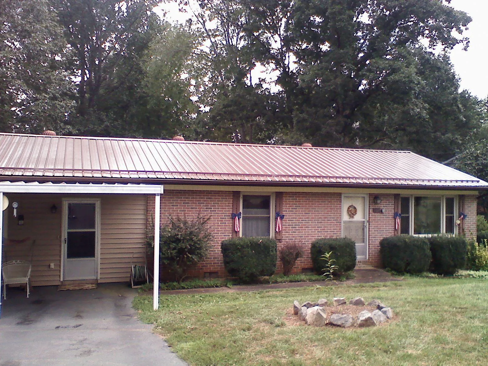 Bronze metal roof and carport on a brick ranch home — Roof Repair work by our crew in Rowland Heights